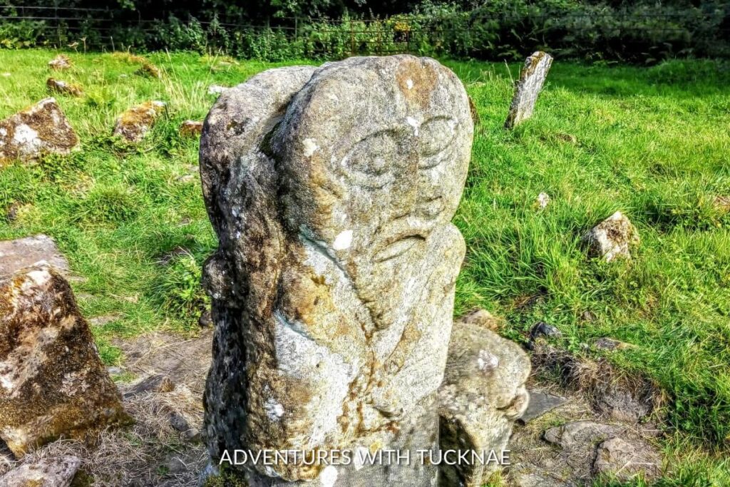An ancient carved stone figure on Boa Island, steeped in history and mystery, a unique sight on a cultural weekend break in Ireland.