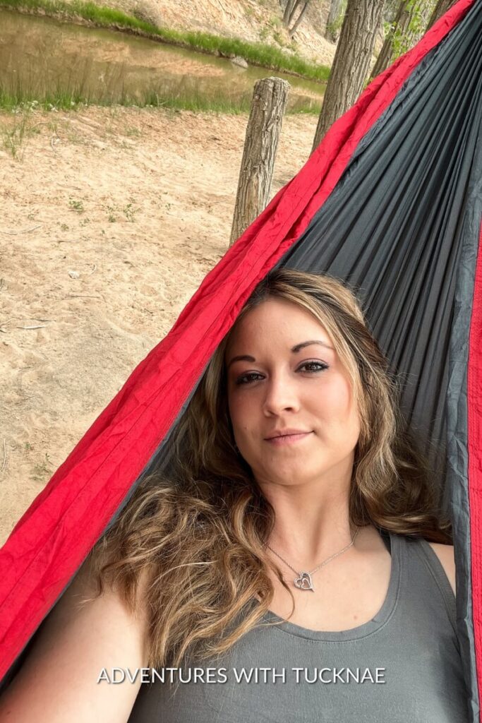Janae from Adventures with TuckNae enjoying a hammock next to a creek near Belly of the Dragon.