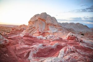 Vibrant striations of red and white rock formations at White Pocket, displaying the surreal landscape of hikes near Kanab, Utah.