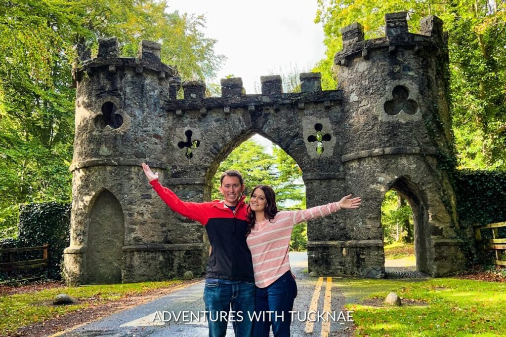 The whimsical gateway at Tollymore Forest Park, with a couple stretching their arms out, invites Instagram adventurers to explore the enchanting landscapes of Northern Ireland.