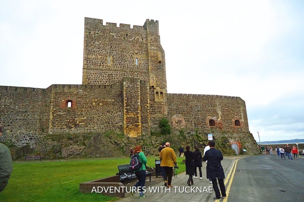 Carrickfergus Castle, standing resilient on the northern shore of Belfast Lough, greets visitors with its robust stone walls and towering keep, an iconic and Instagrammable landmark steeped in the history of Northern Ireland.