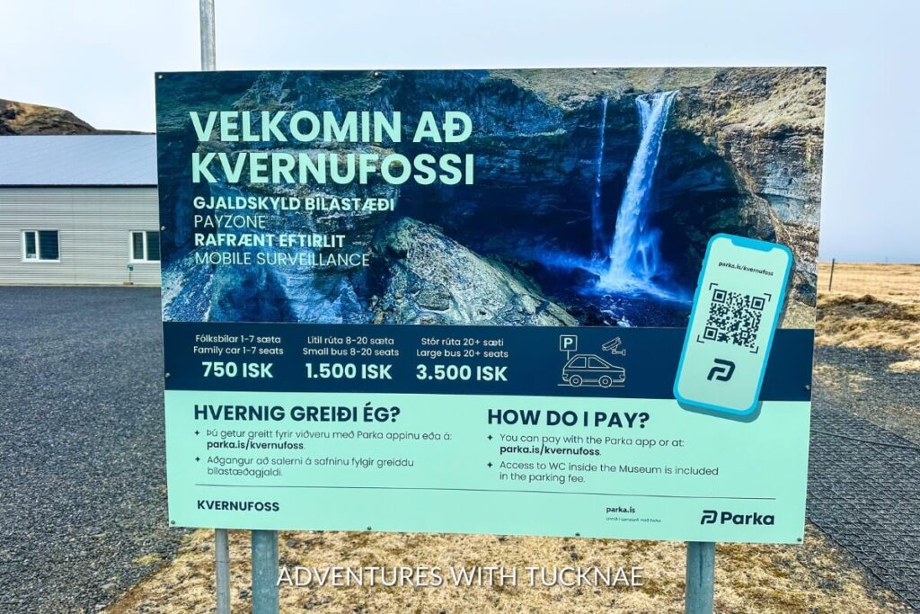 The parking fee sign at Kvernufoss for the Parka app. It shows that the price for a family car is 750 ISK, a small bus is 1.500 ISK, and a large bus is 3.500 ISK. 