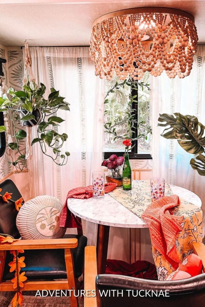 A stunning RV renovation with a custom chandelier and lots of plants