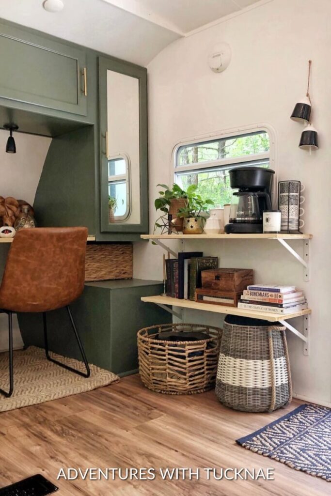 A green and white RV renovation with added shelves on the wall