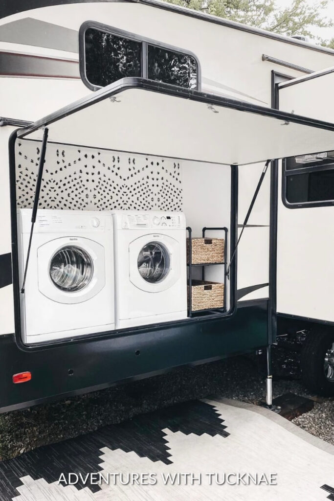 An renovated RV outdoor kitchen turned into a laundry space with a washer and dryer