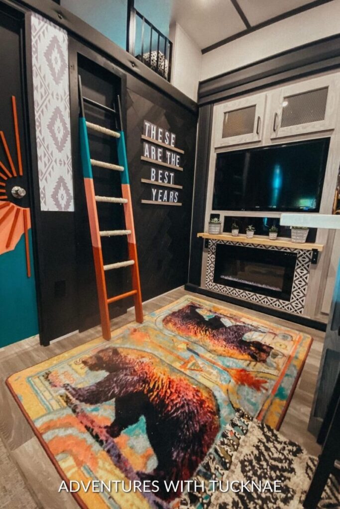 A dark and dramatic RV renovation with black, orange, and blue accents.