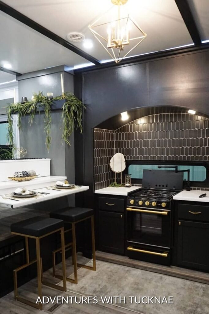 A dark and dramatic RV kitchen renovation that is black and white.