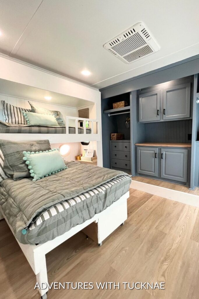 A sleek, modern RV bedroom remodel with green and deep blue accents