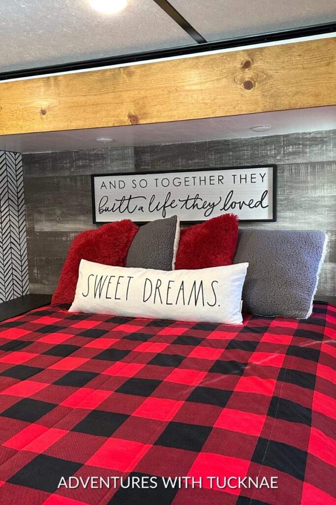 A modern RV bedroom makeover with black, white, and red accents