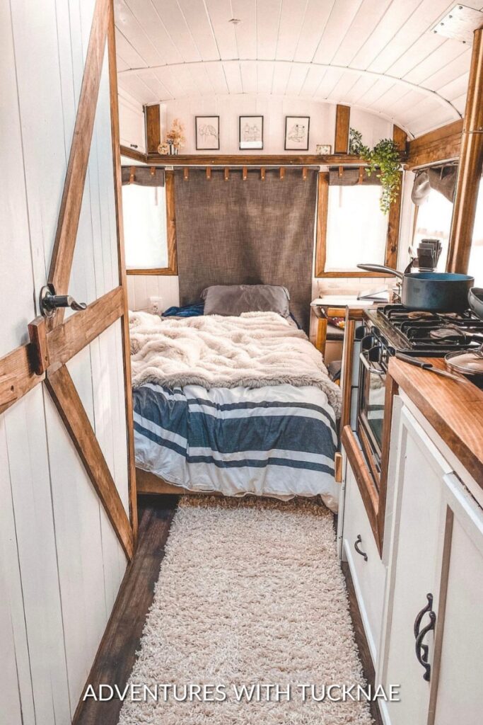 A cozy RV bedroom renovation with lots of wood and earthy tones