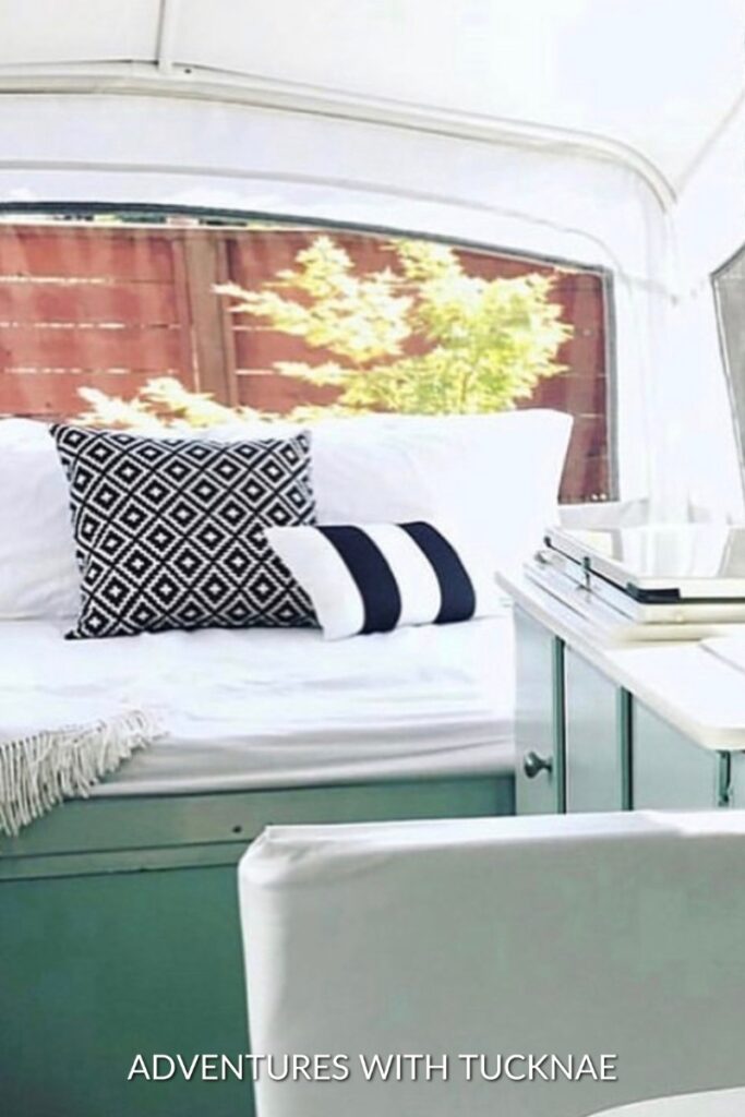 A cute RV renovation with black, white, and green accents