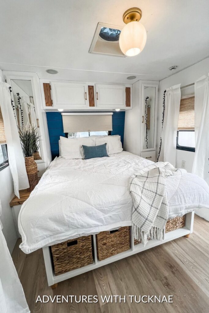 A modern blue and white RV renovation with wood accents
