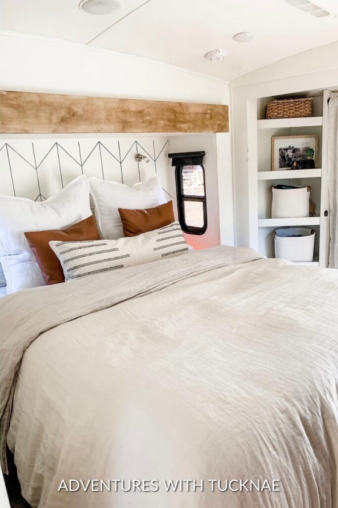 A modern RV bedroom remodel with white and earth tones