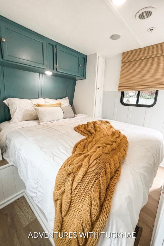 A modern and simple RV bedroom renovation with teal blue and mustard yellow accents