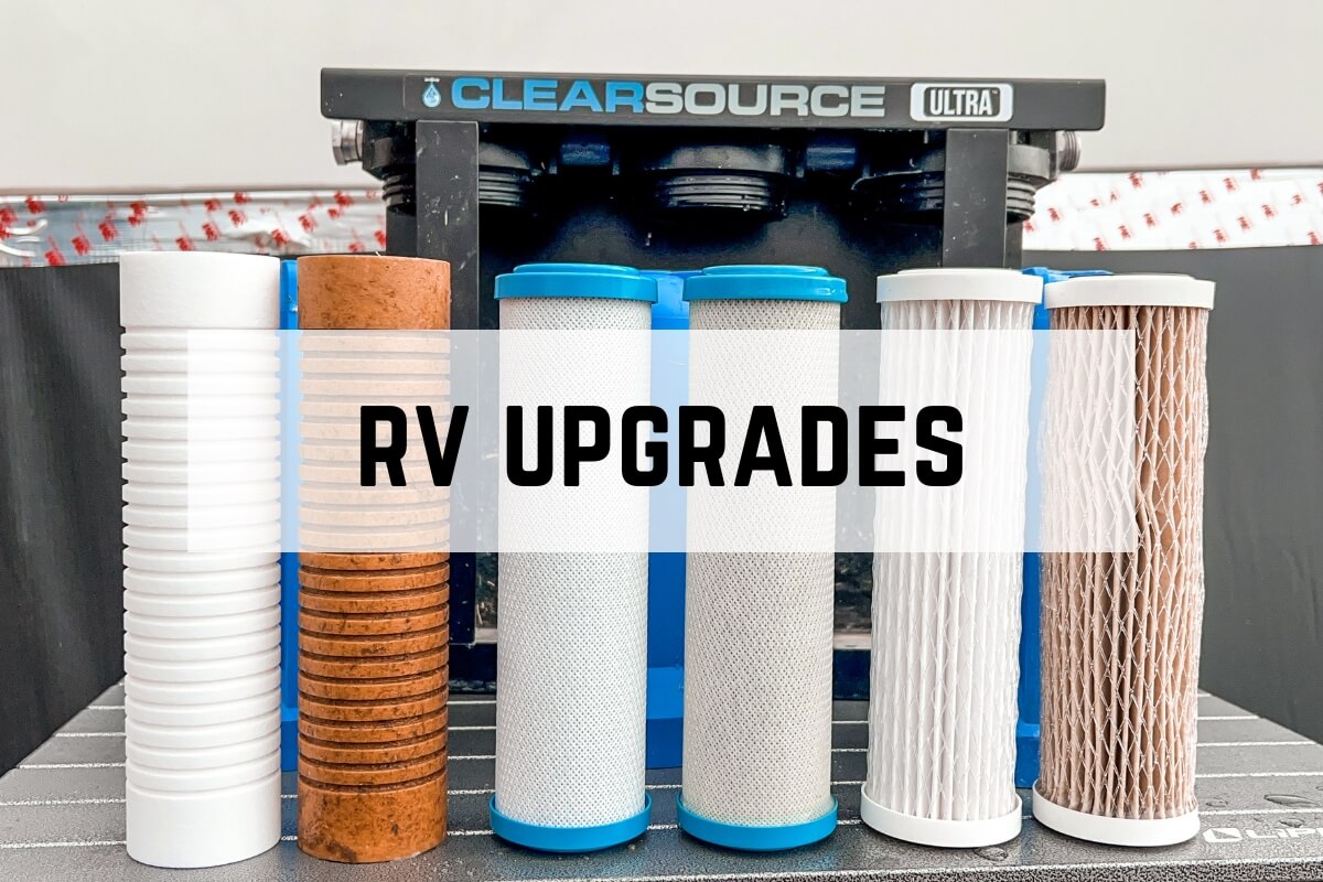A lineup of various RV water filters stands in front of a ClearSource Ultra water filtration system. Text over the image reads “RV Upgrades.”